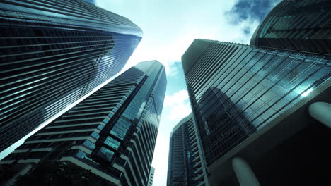 Modern-business-architecture-with-glass-and-steel-walls-reflecting-sky-clouds