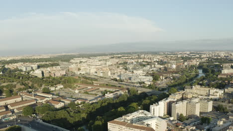 Aerial-dolly-to-quiet-corner-of-Trastevere-neighborhood-Rome-Italy-by-the-river-as-train-enteres-city