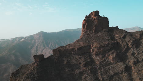 Roque-Bentayga:-aerial-view-in-orbit-of-the-famous-rock-structure-on-the-island-of-Gran-Canaria,-Tejeda,-Canary-Islands,-Spain