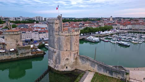 Bird's-eye-aerial-view-about-the-Saint-Nicolas-Tower-and-chain-tower,-La-Rochelle,-France