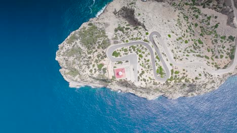 Aerial-top-down-view-sideways-motion-over-Formentor-Lighthouse,-Mallorca