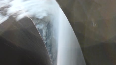 Closeup-of-machinery-on-snowblowing-chute-while-in-function-at-night