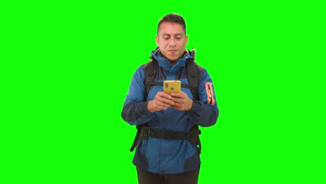 Man-with-hiking-backpack-and-yellow-smartphone-in-studio