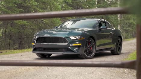 A-tripod-shot-of-a-Ford-Bullitt-Mustang-posed-behind-a-cattle-gate