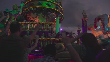 People-throwing-candy-and-necklaces-from-a-big-truck-at-a-parade