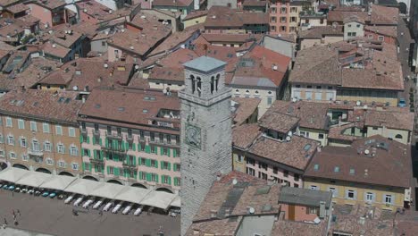 Amazing-drone-view-of-an-old-belfry-in-the-center-of-the-small-italian-city-Riva-Del-Garda-in-the-region-of-Trento,-North-Italy