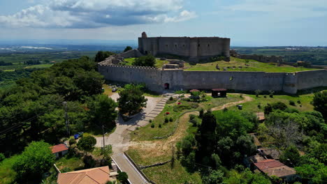 The-historic-chlemoutsi-castle-museum-surrounded-by-lush-green-landscape,-aerial-view