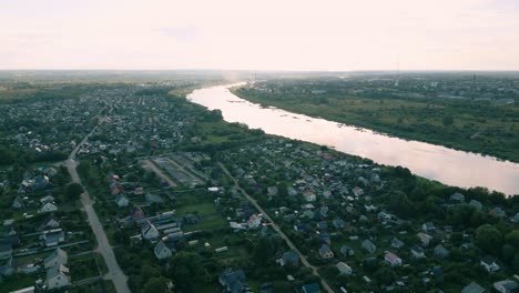 Aerial-view-of-Daugavpils,-Latvia,-featuring-winding-Daugava-River-at-dusk