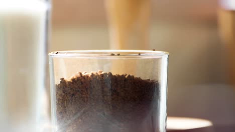 Pouring-Coffee-Granules-into-glass-jar