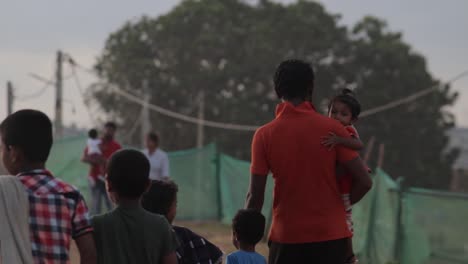 Little-daughter-on-fathers-arm-holding-the-son's-hand-walking-with-other-kids-in-Galle-fort-evening,-Perfect-example-of-happy-childhood-memories