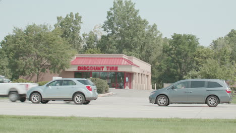 Discount-Tire-located-in-Okemos,-Michigan-with-cars-driving-by-and-stable-wide-shot