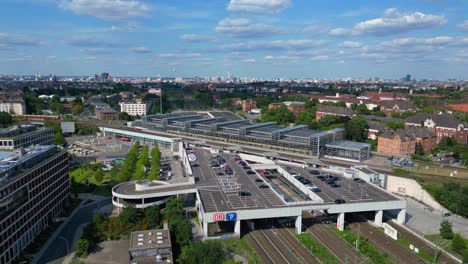 Perfect-aerial-view-flight-speed-ramp-hyper-motion-time-lapse-of-modern-train-station-platform-with-glass-roof-in-the-city-Berlin