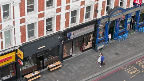 Walking-past-the-Bus-Stop-in-Shoreditch,-London,-United-Kingdom