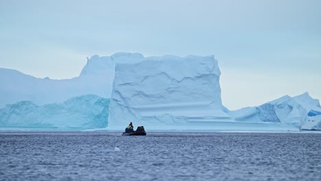 Antarctica-Boat-Trip-and-Iceberg-Scenery-in-Winter-Ice-on-Antarctic-Peninsula,-Tourists-People-Traveling-in-Beautiful-Dramatic-Landscape-on-Zodiac-Boat-Tour,-a-Unique-Adventure-Travel-Experience