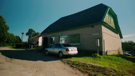 View-from-an-Audi-car-parked-in-front-of-Veikals-shop-in-a-Latvian-village-during-summer