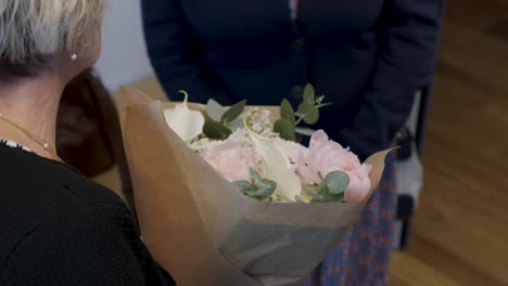 Slow-motion-shot-of-a-mother-holding-a-bouquet-of-flowers-at-a-wedding