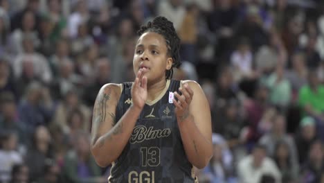 Slow-motion-shot-of-a-female-professional-basketball-player-in-a-stadium