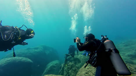 Shot-of-a-snorkeler-clicking-picture-of-other-mate-underneath-sea-in-Greece