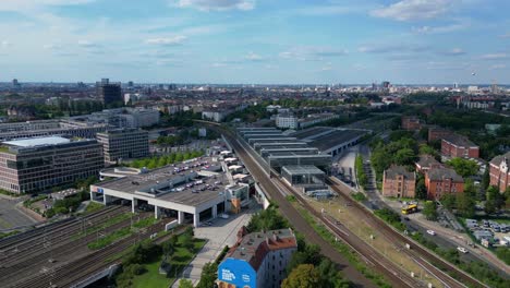 Great-aerial-view-flight-speed-ramp-hyper-motion-time-lapse-of-modern-train-station-platform-with-glass-roof-in-the-city-Berlin