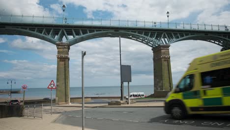 footage-of-Spa-Bridge-in-South-Bay,-Scarborough,-North-Yorkshire-on-a-summer-day-on-a-busy-weekend-with-people-walking-over-the-bridge