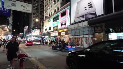 Street-traffic-in-busy-Mong-Kok-district-of-Hong-Kong-at-night,-static