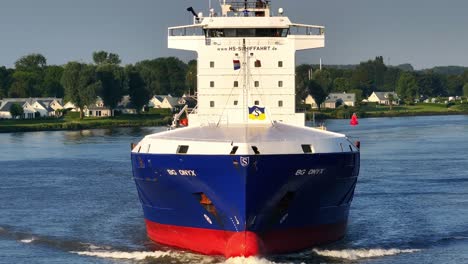 Majestic-container-vessel-glides-through-water,-hull-laden-with-commerce