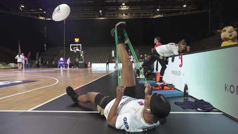 Slow-motion-shot-of-professional-basketball-athletes-stretching-before-a-game