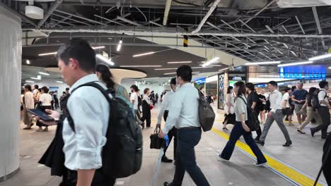 Slow-motion-movement-of-people-walking-at-a-metro-station-hub