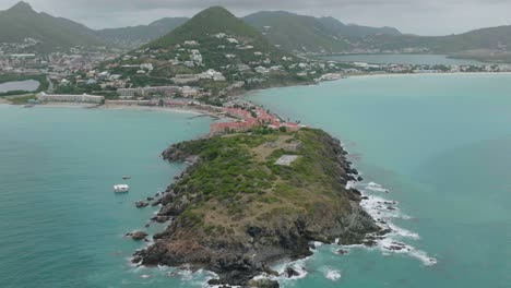 Aerial-shot-of-Fort-Amsterdam-Sint-Marteen-on-island-during-daytime-with-beautiful-hills-at-background