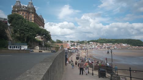 footage-of-The-Grand-Hotel-and-South-Bay-beach,-Scarborough-in-July-on-a-weekend,-North-Yorkshire-on-a-summer-day-on-a-busy-weekend-with-families-enjoying-the-English-coastal-seaside-resort