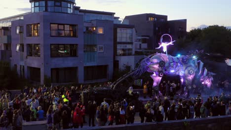 Pan-shot-showcasing-the-stunning-Pegasus-parade-in-Galway-city,-enhanced-with-smoke-and-lights,-mesmerizing-the-crowd