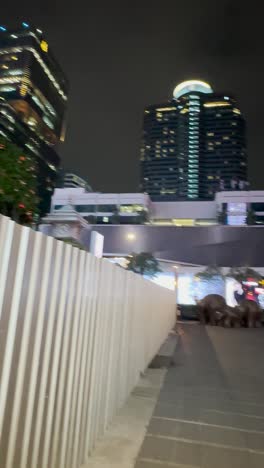 A-night-view-of-many-skyscrapers’-buildings-with-empty-walking-paths