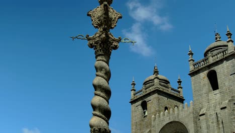 A-spiral-thing-in-the-middle-of-a-fountain-by-a-cathedral-in-Porto,-Portugal