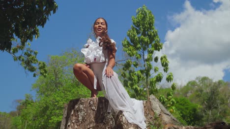 The-sun-shines-down-on-a-young-girl-in-white-enjoying-the-Botanical-Gardens-in-Trinidad,-Caribbean