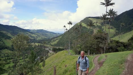 Male-hiker-walks-toward-camera-in-beautiful-Cocora-Valley-of-Colombia