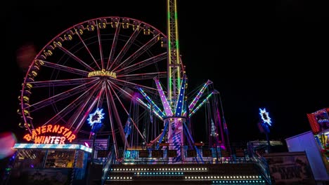 Night-Time-lapse-of-illuminated-Funfair-Rides,-Motion-Blur