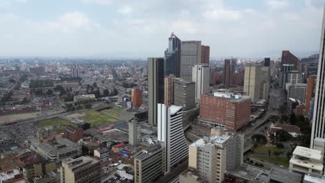 Low-city-flight-to-highrise-skyscrapers-on-Bogota,-Colombia-skyline