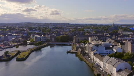 Aerial-dynamic-shot-of-the-Long-walk,-River-Corrib-and-vibrant-Galway-city