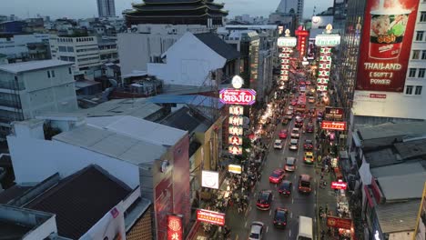 La-Bulliciosa-Calle-Chinatown-De-Bangkok,-Tailandia,-Por-La-Noche,-Con-El-Horizonte-Al-Atardecer-Y-El-Atasco-De-Tráfico