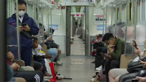 Passengers-in-train-immersed-in-mobile-phones-and-other-personal-activities