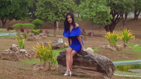 In-the-Caribbean,-on-the-island-of-Trinidad,-a-girl-in-a-blue-dress-enjoys-a-sunny-park