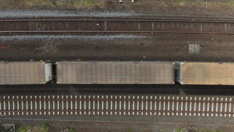 Drone-view-of-the-train-tracks-as-a-train-passes,-Darmstadt,-Germany