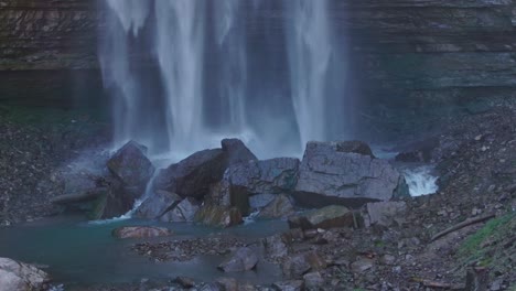 Waterfall-cascading-over-rocks-into-a-serene-pool-in-a-tranquil-nature-setting