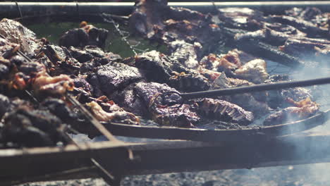 Close-up-of-chef-eating-roasted-meat-on-grill