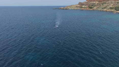 Jet-Skiing-Over-Seascape-Near-Qarraba-Bay-In-Lido,-Mġarr,-Malta