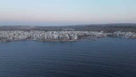 Aerial-View-Of-The-Waterfront-Cityscape-Of-St-Paul`s-Bay-Marina-In-Bugibba,-Malta-Island