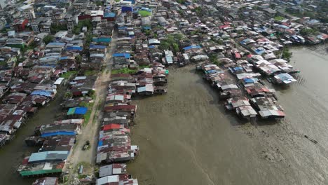 Rustic-roof-tops-of-buildings-on-low-tide-mud-flat,-Buenaventura,-COL