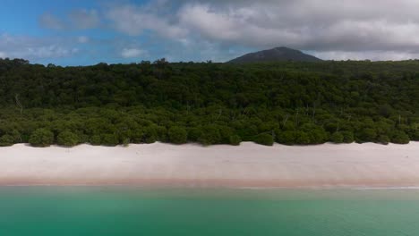 Scenic-Whitehaven-Beach-white-sand-beach-front-aerial-drone-Whitsundays-Island-Airlie-National-Park-Australia-sunny-sun-cloud-motion-blue-sky-outer-Great-Barrier-Reef-clear-blue-aqua-ocean-static