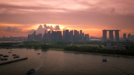 Iconic-Marina-Bay-Sands-hotel-and-Singapore-skyline-backlit-by-vibrant-sunset