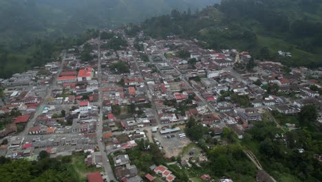 Aerial-tilts-down-to-charming-streets-of-Salento-Colombia-on-mtn-ridge